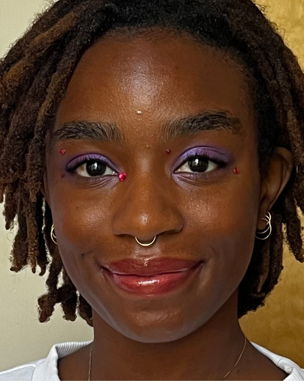 Model wears purple, shimmery jewel-toned makeup