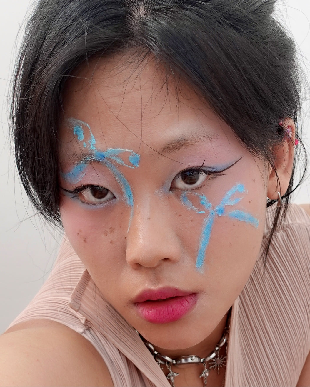 Model wears graphic bow makeup