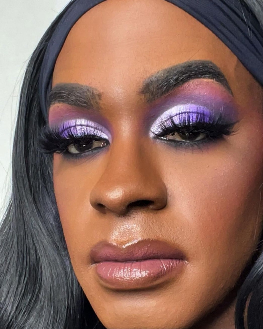 Model wears colorful eye makeup with colorful eyelashes for holiday makeup inspiration