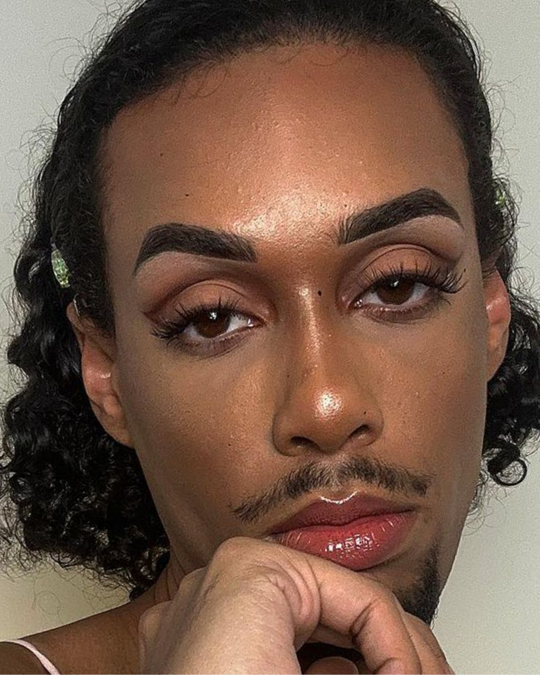 Model wears graphic smoky eye makeup for holiday makeup inspiration