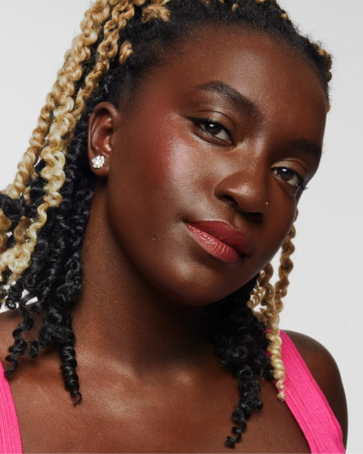 Model wears Milk Makeup Lip + Cheek in Flip on a white background.