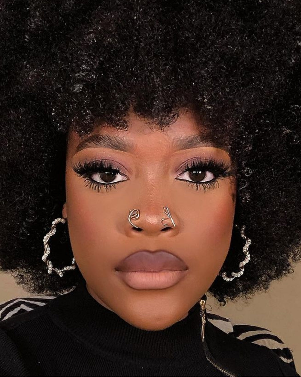 Portrait of a woman with an Afro wearing neutral matte makeup holiday makeup inspiration