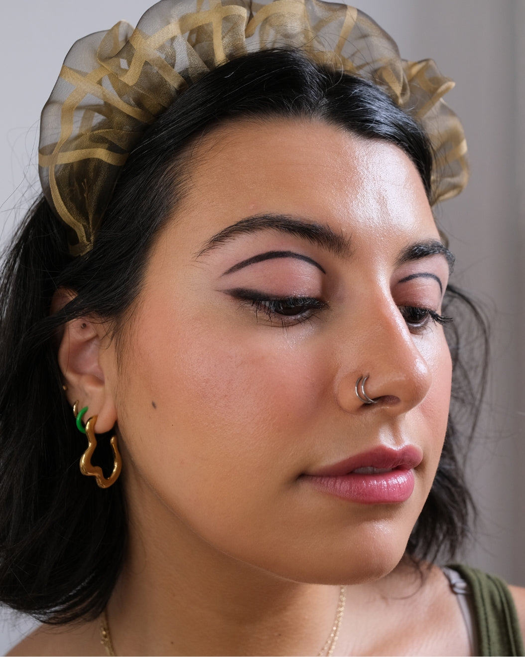 Portrait of a woman wearing graphic eyeliner to use for holiday makeup inspiration