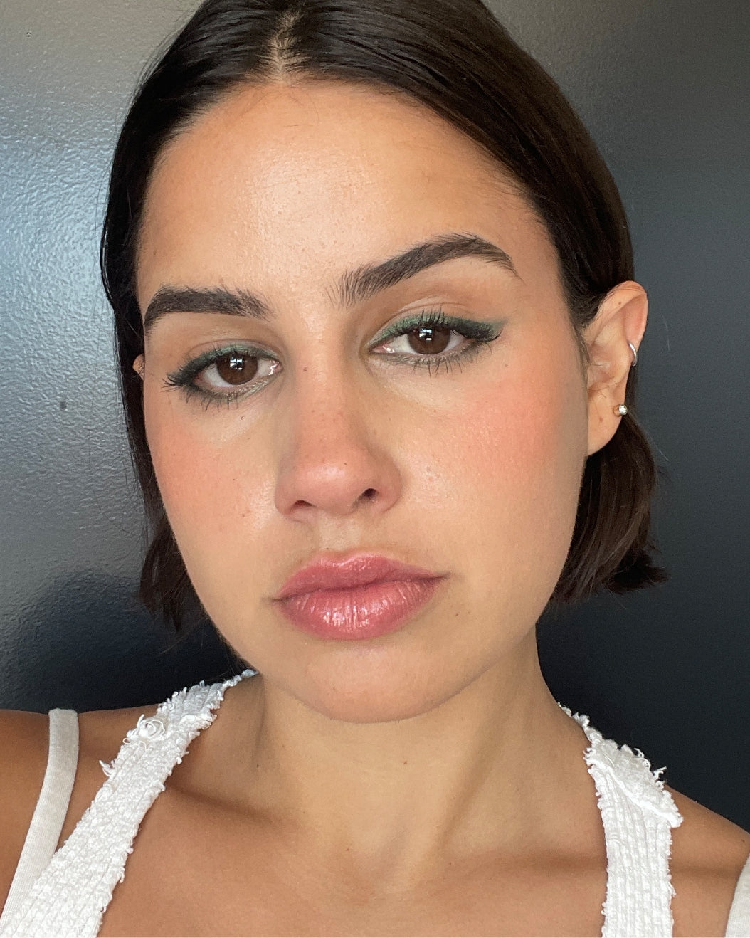 Stefani wears Milk Makeup Color Chalk in Green Light for a winged eyeliner look