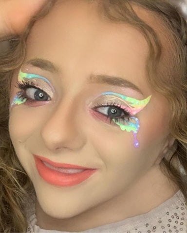 Model wears graphic pastel rainbow eye makeup