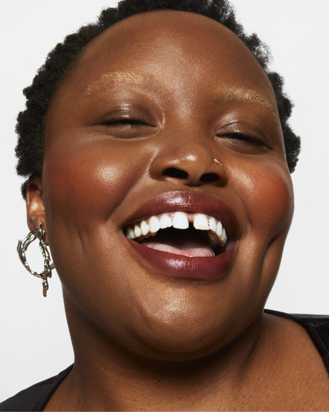 Shot of a model after applying Milk Makeup KUSH Brow Lamination Gel to their brows on a white background