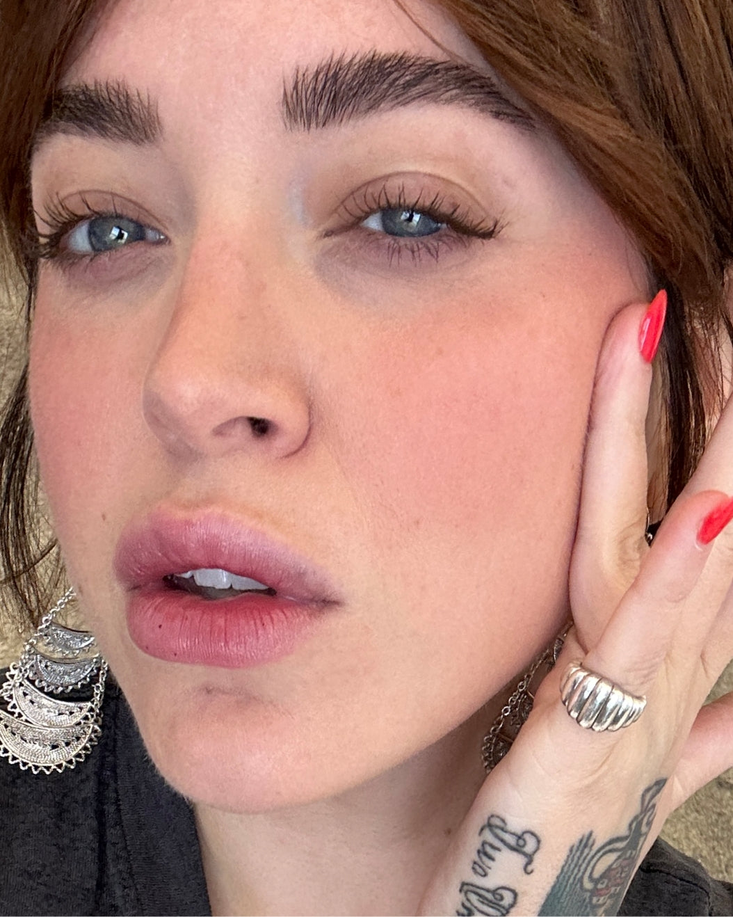Selfie of a woman with a medium-light skin tone wearing Milk Makeup Lip + Cheek in Quickie