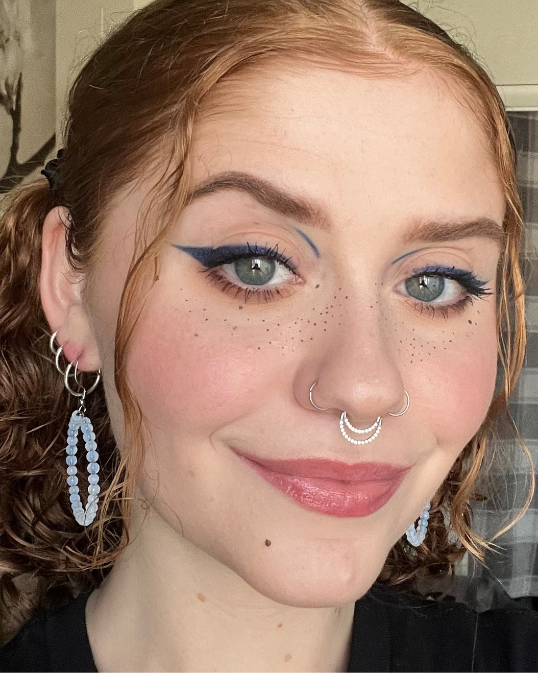 Selfie of a makeup artist wearing blue eyeliner, Milk Makeup Infinity Eyeliner in Time.