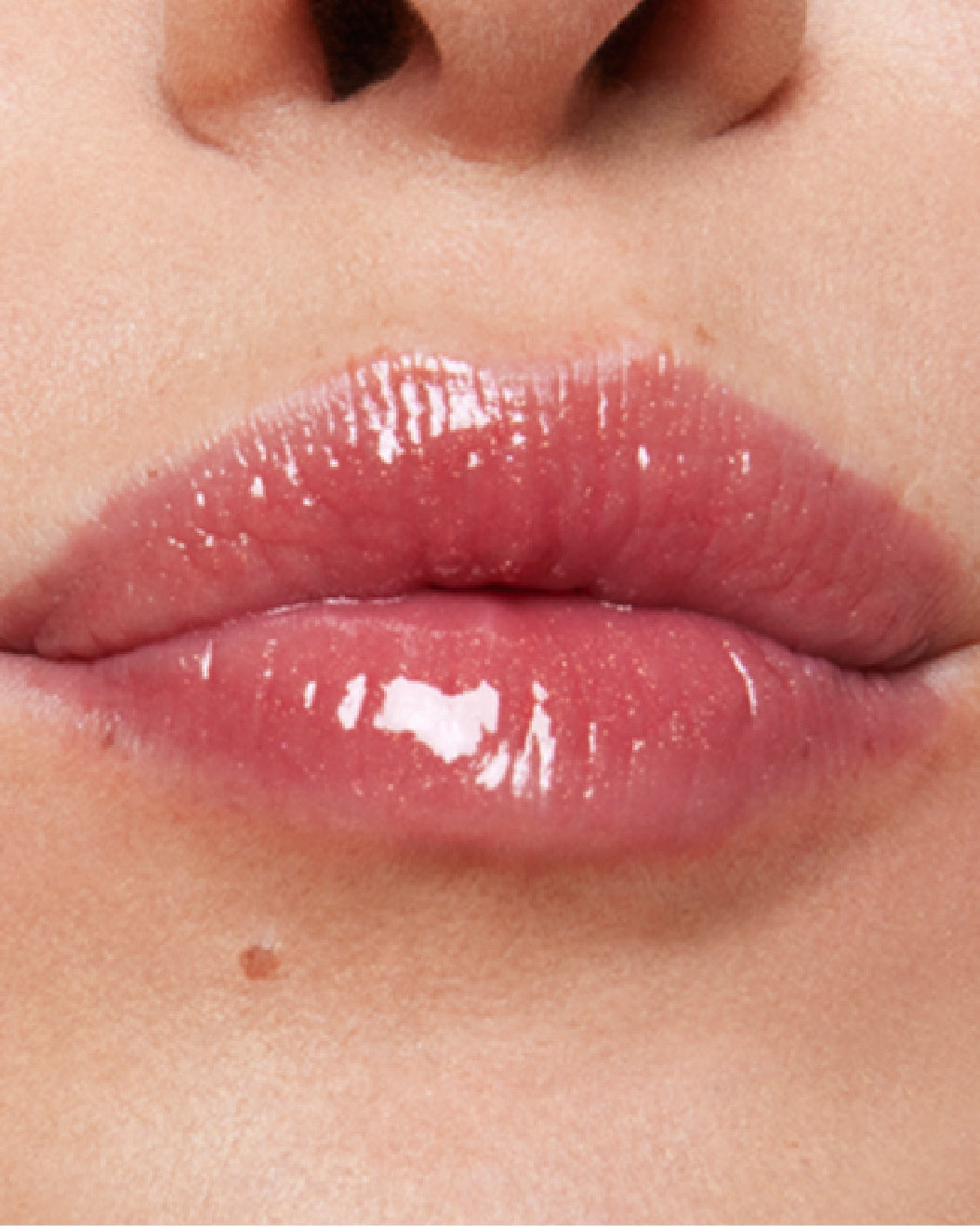 Close-up of model's lips wearing Milk Makeup Odyssey Lip Oil Gloss in Soul Search