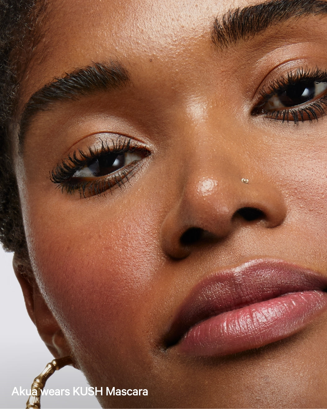 A model wears Milk Makeup KUSH Mascara for volumized lashes