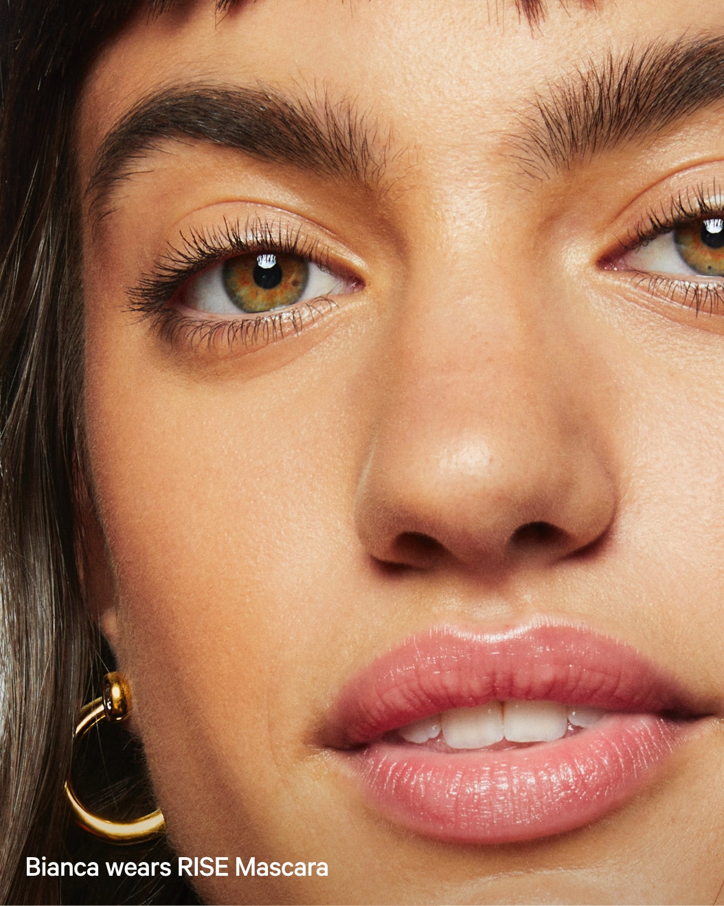 A model wears Milk Makeup RISE Mascara for long lashes