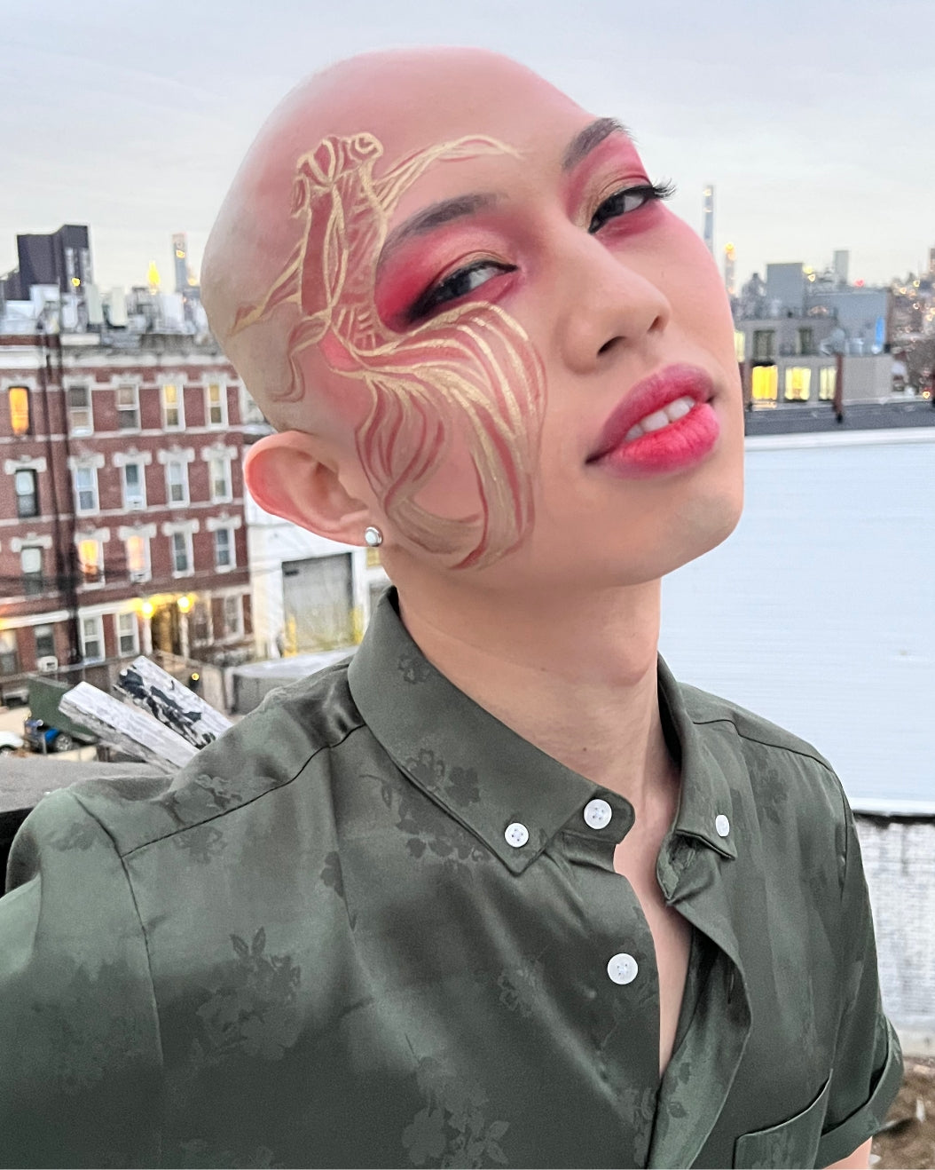 Close-up portrait of Johnathan Nguyen wearing a goldfish-inspired makeup look for Lunar New Year