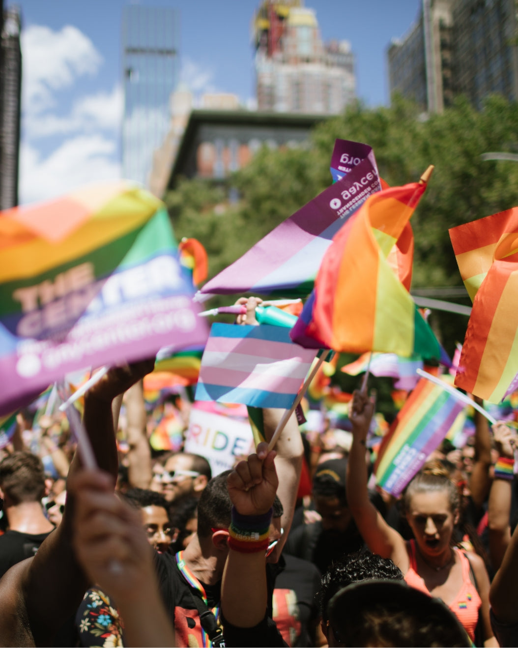 New Yorkers waving Pride flags and flags for The Center
