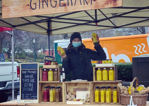 A woman selling ginger elixir at her booth at craft 