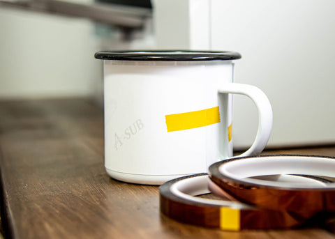 A white camping mug during the sublimation process