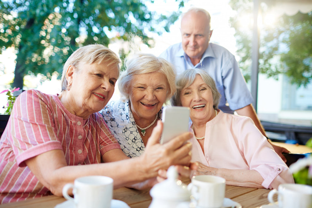 older people having conversation with invisible haring aids