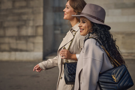 friends filled with joy rocking their designer handbags