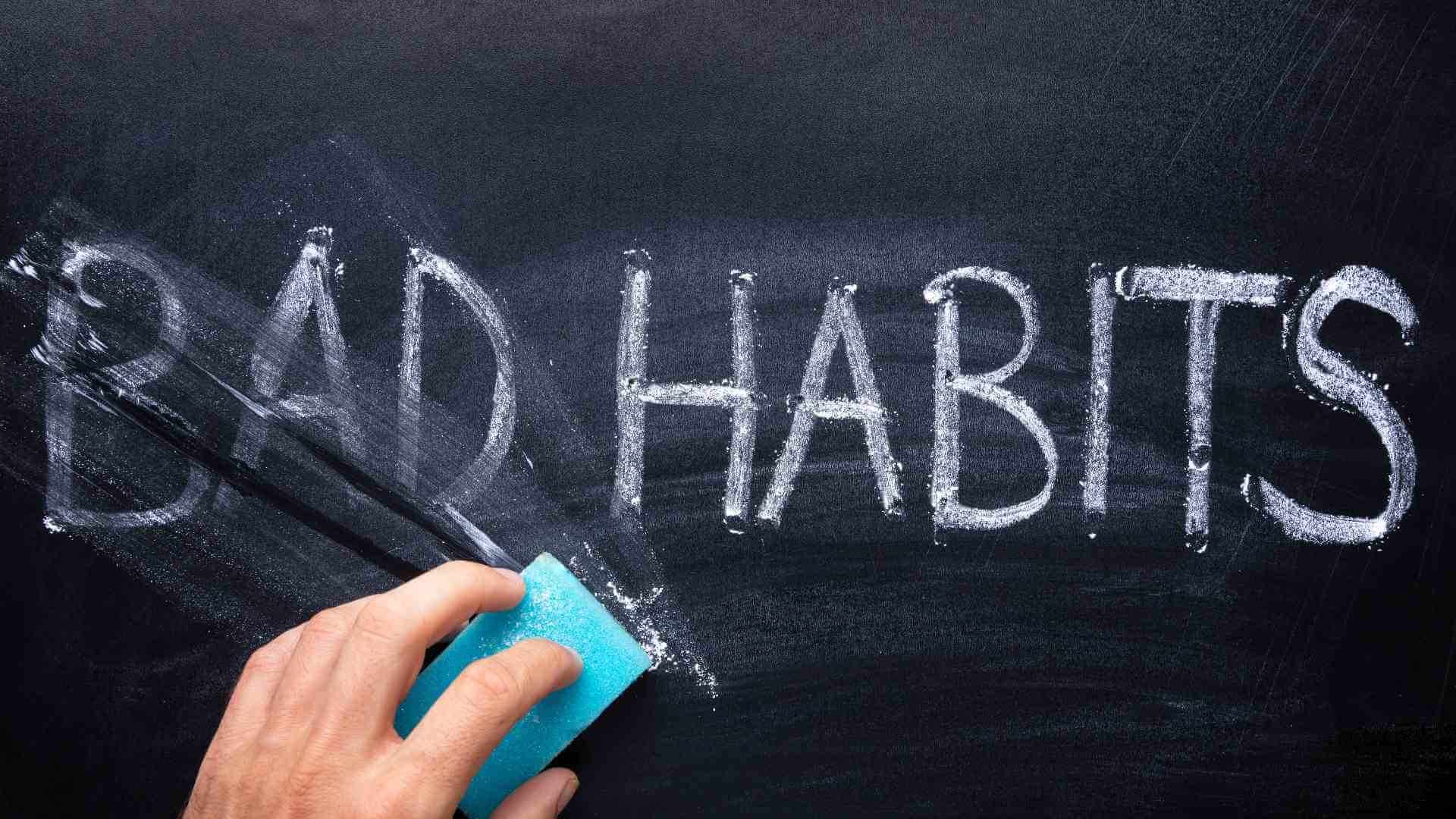 Erasing the word "bad habits" on a blackboard