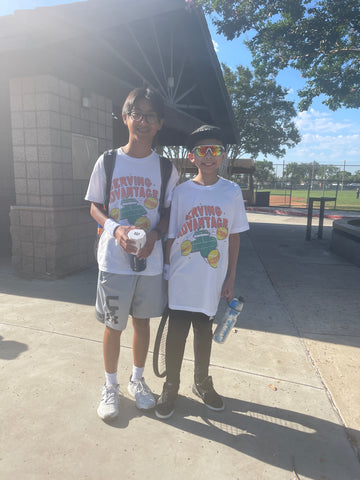 Serving Advantage doubles team Gavin Wong and Konhee Lee smiling as they get ready to enter the tennis courts.