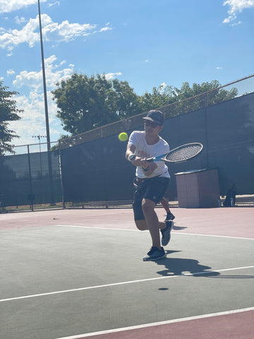 Adaptive athlete Jacob moving to hit the tennis ball