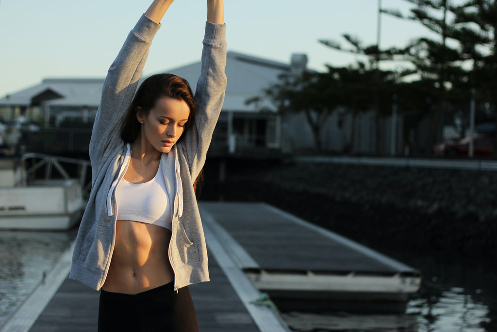 Woman stretching outdoors after exercise