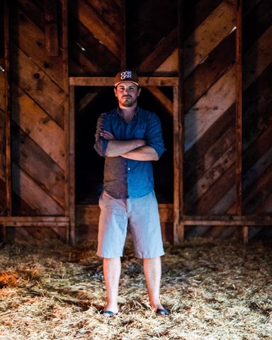 photo of Dan standing in barn loft.