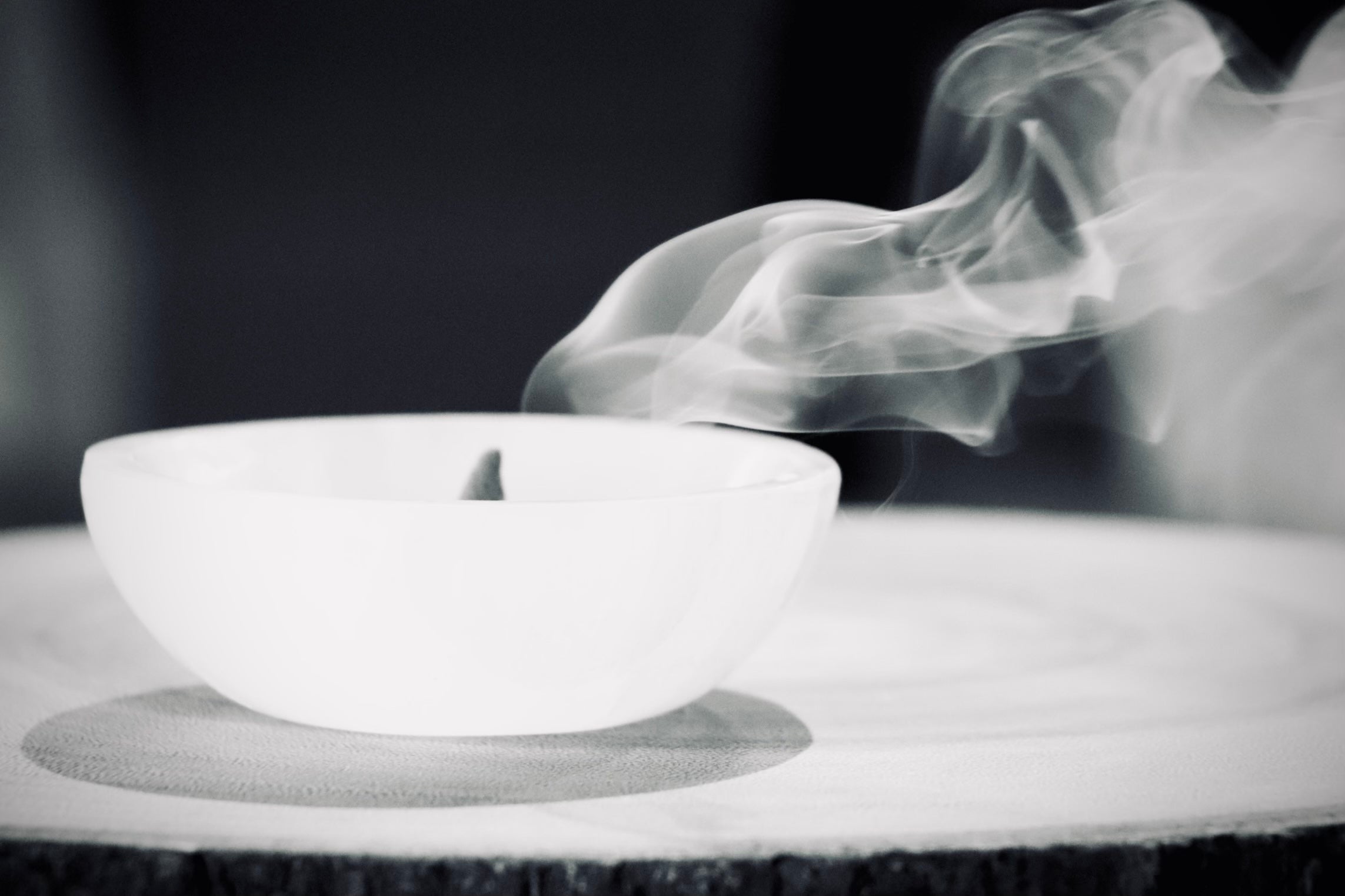 selenite bowl with incense cone burning