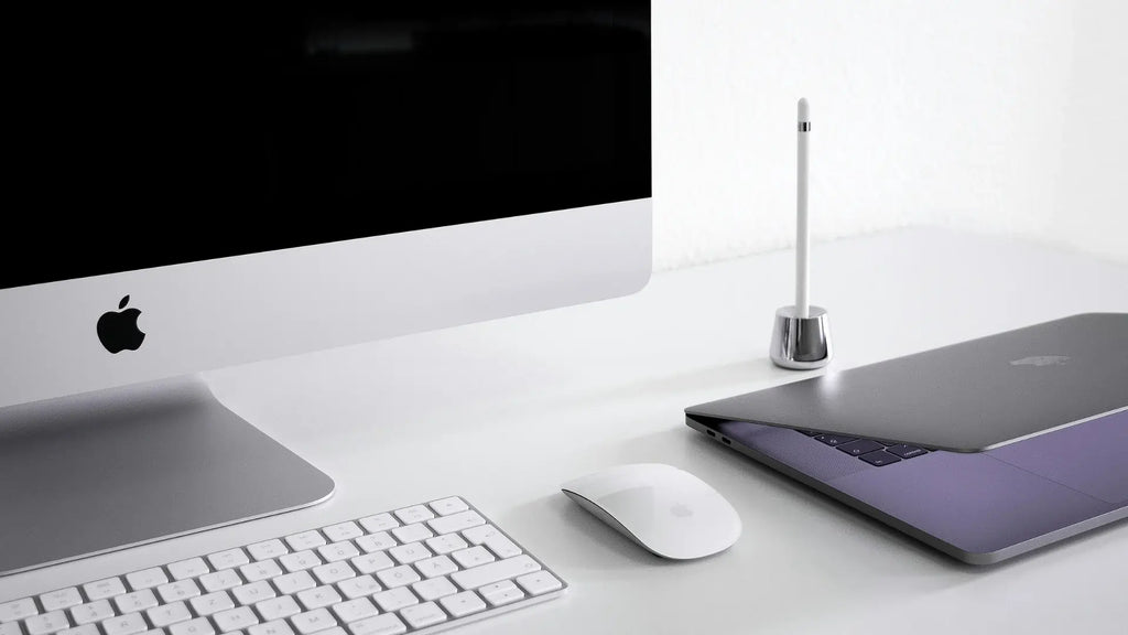 iMac 24 inch with a Macbook Pro next to it and a Magic Mouse