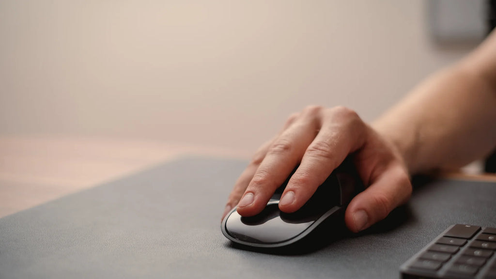 Hand on a Magic Mouse with ergonomic Solumics Case