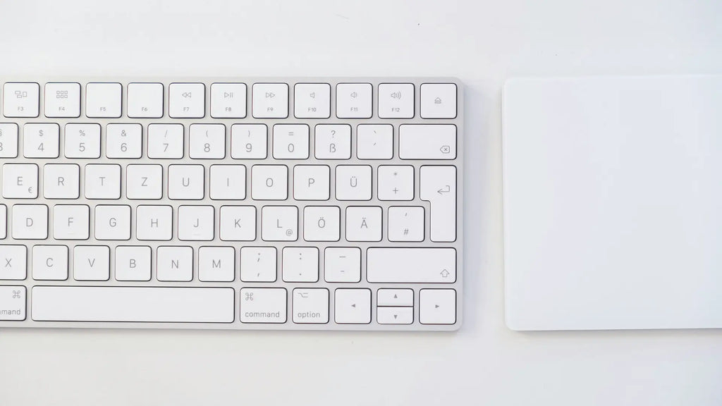 apple magic trackpad next to apple keyboard