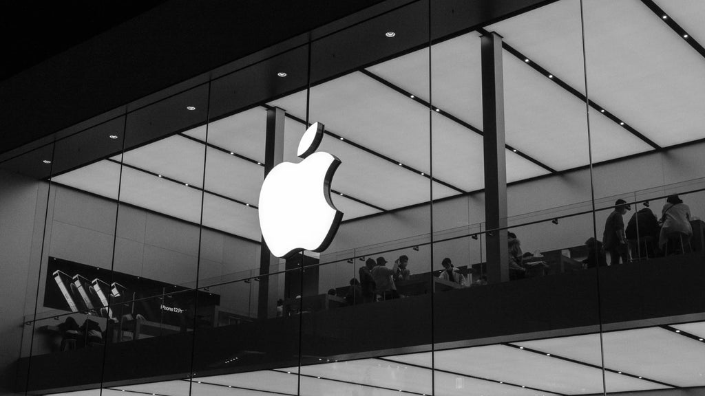 apple logo on a glass wall of an apple store