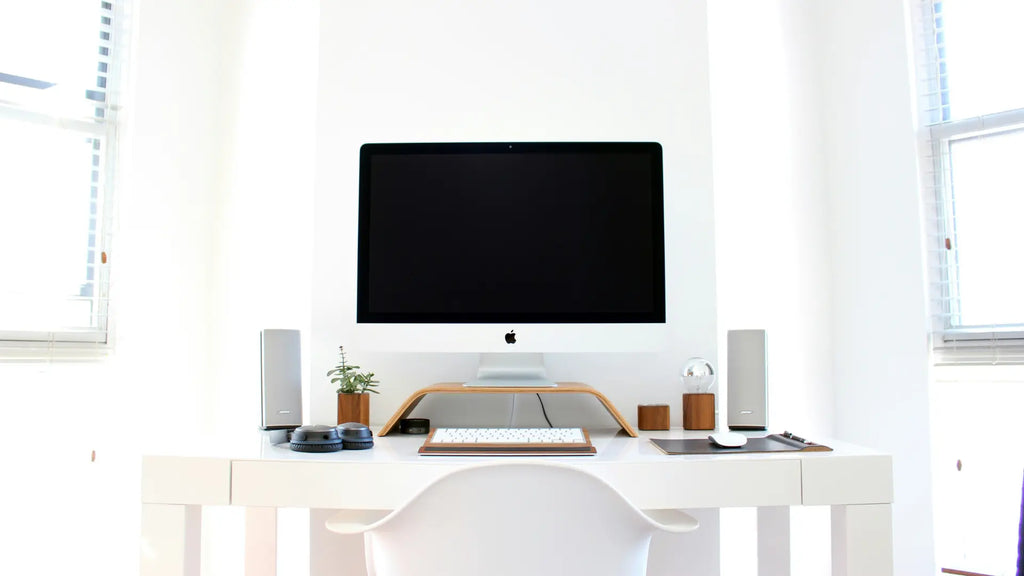 work desk with desktop imac, keyboard and magic mouse
