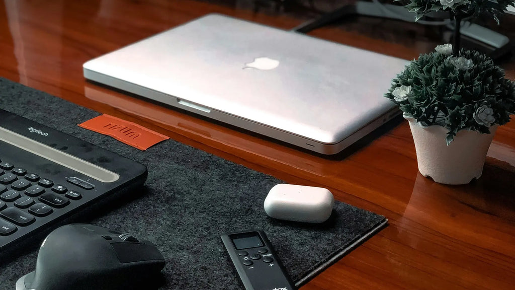 logitech mouse with macbook on a desk
