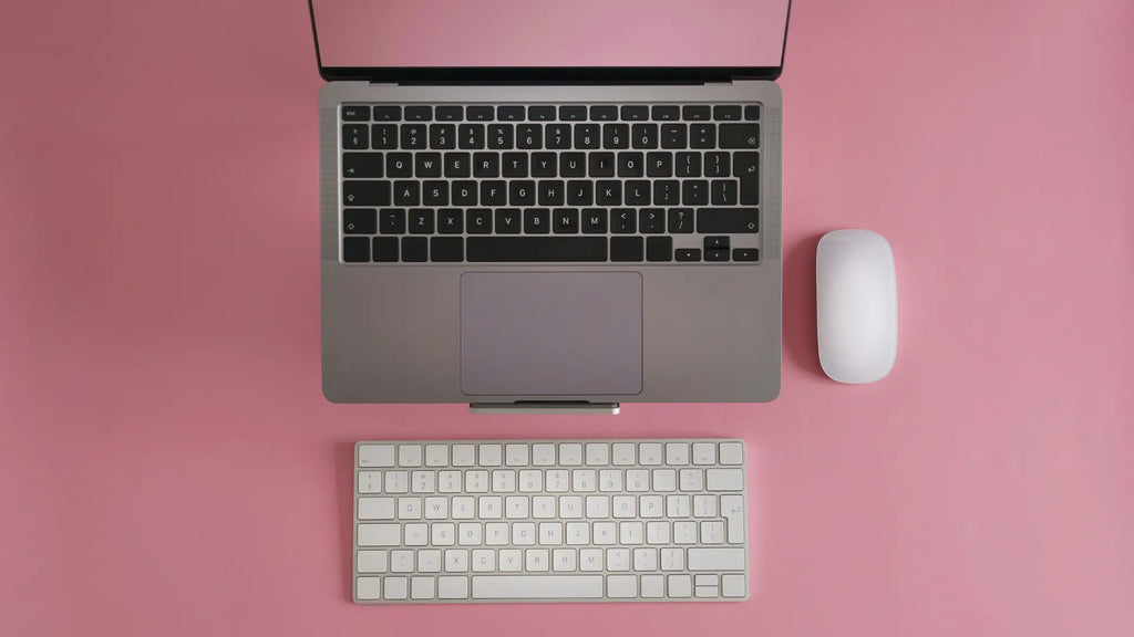 mac book with a magic mouse and keyboard