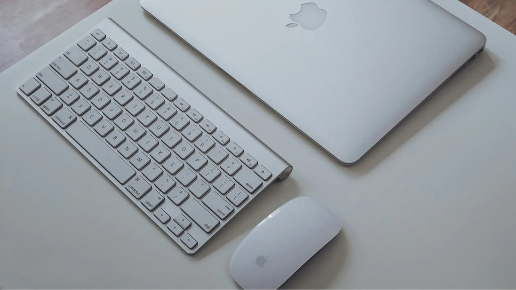 macbook with a keyboard and magic mouse