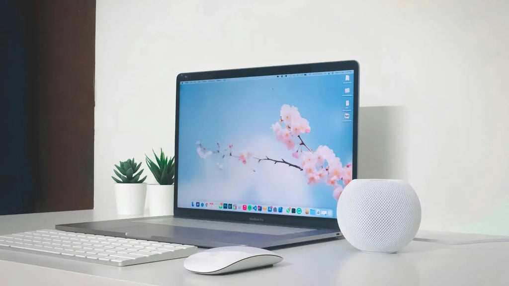 macbook with keyboard and magic mouse on workdesk