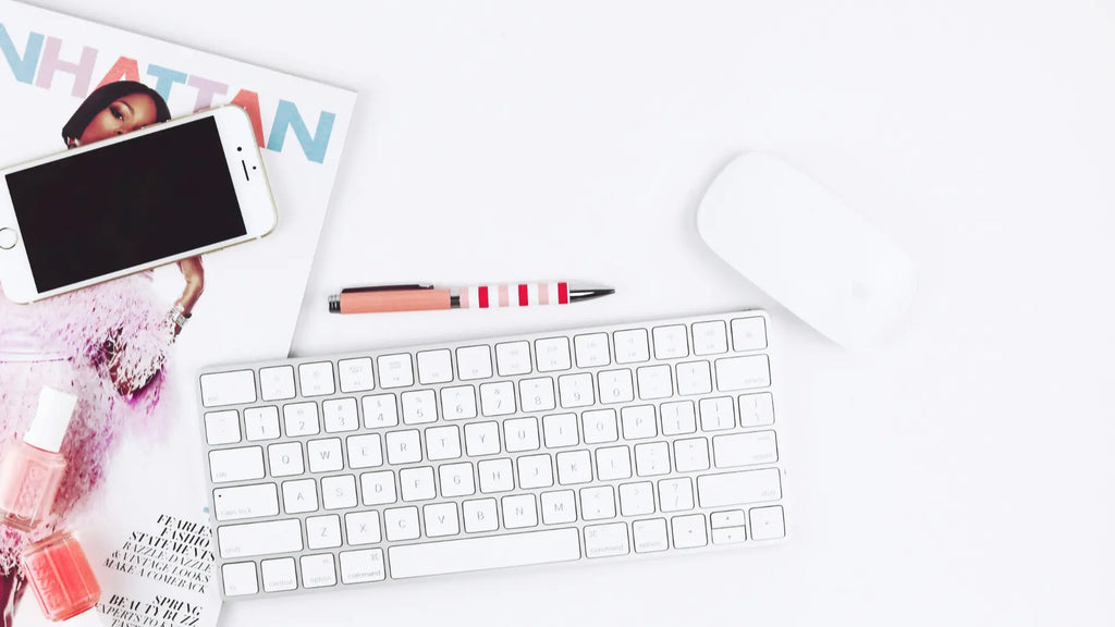 magic mouse, keyboard and iphone on a desk