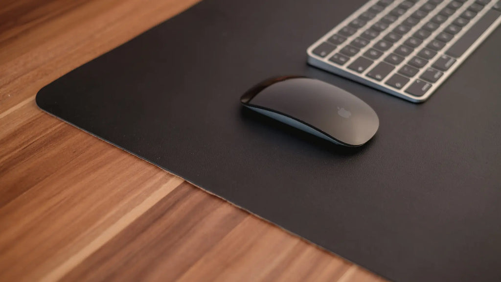 magic mouse on black desk mat