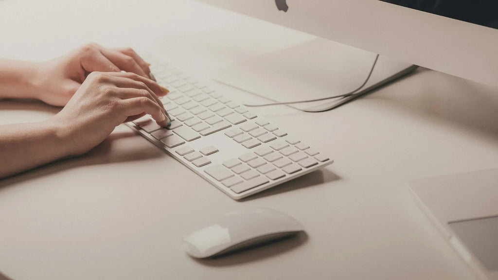 person using magic keyboard and magic mouse