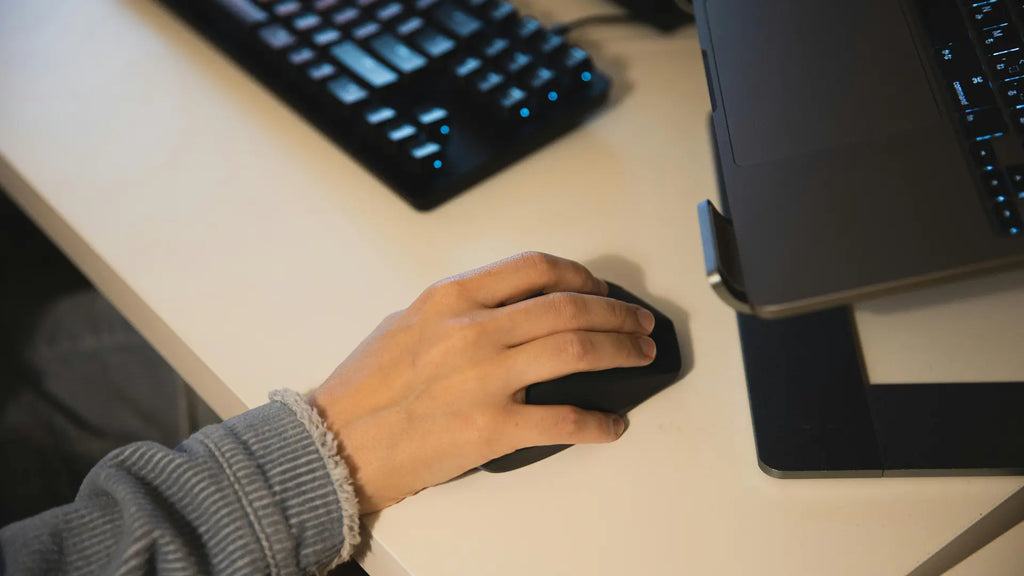person working with ergonomic mouse