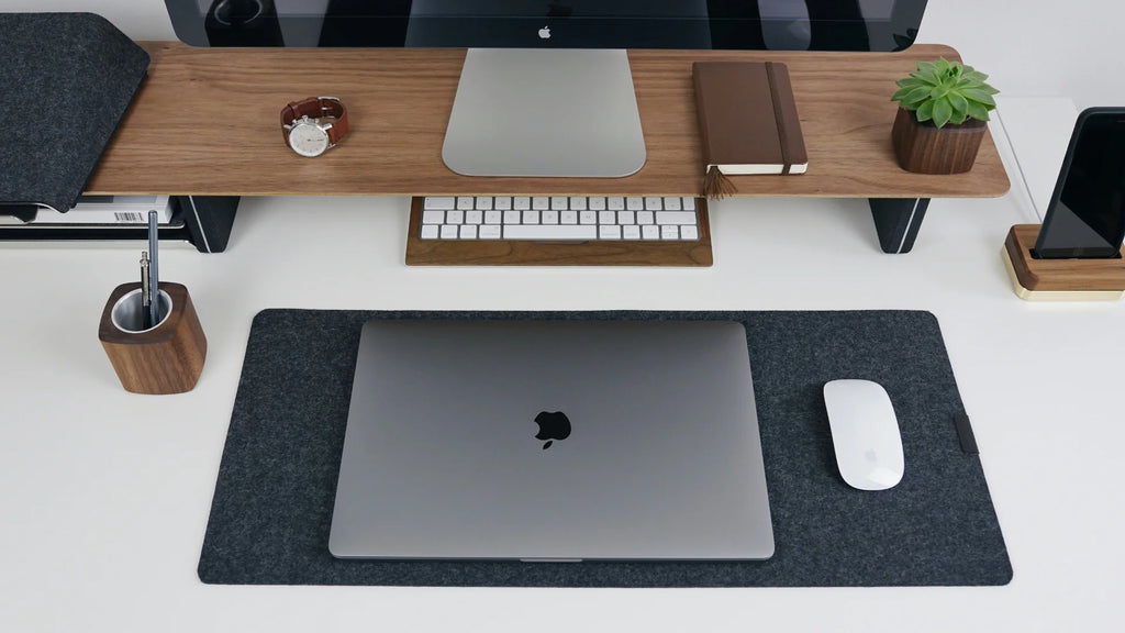 workdesk with magic mouse and macbook on a large mousepad