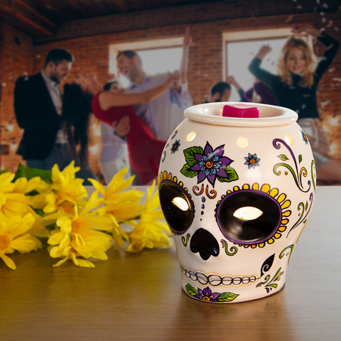 skull wax warmer and people dancing behind