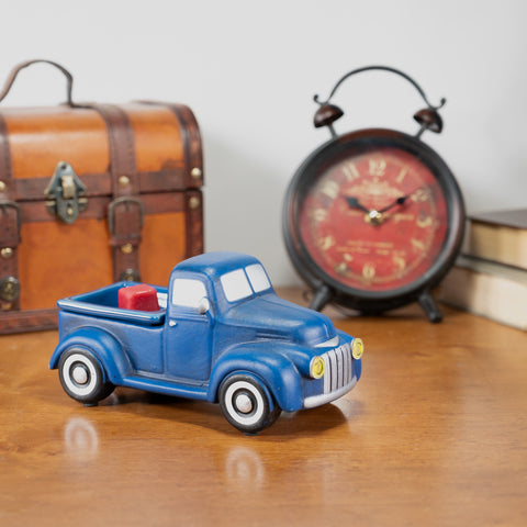 Blue truck wax warmer on a table next to a clock and briefcase