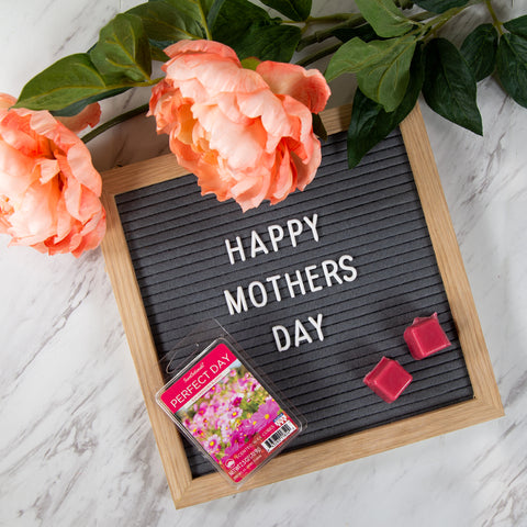 Happy Mothers Day wooden message board with flowers and wax melts on top