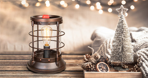 Light bulb wax warmer next to tabletop Christmas decorations