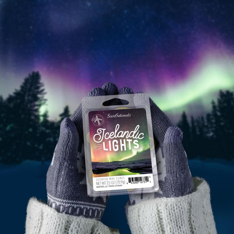 Hands holding Icelandic Lights wax melts under the Northern Lights