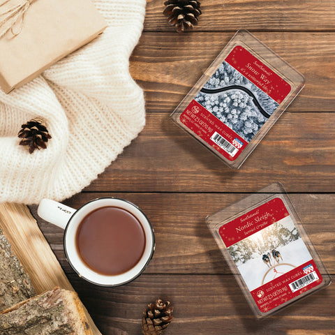 Winter themed wax melts on a table next to a cup of hot chocolate