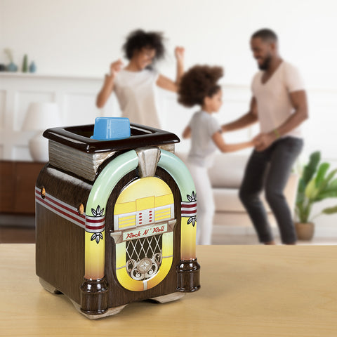 Family dancing behind a table with a juke box themed wax warmer