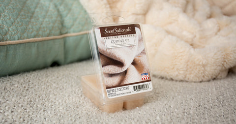 Scented wax cubes next to a blanket and pillow