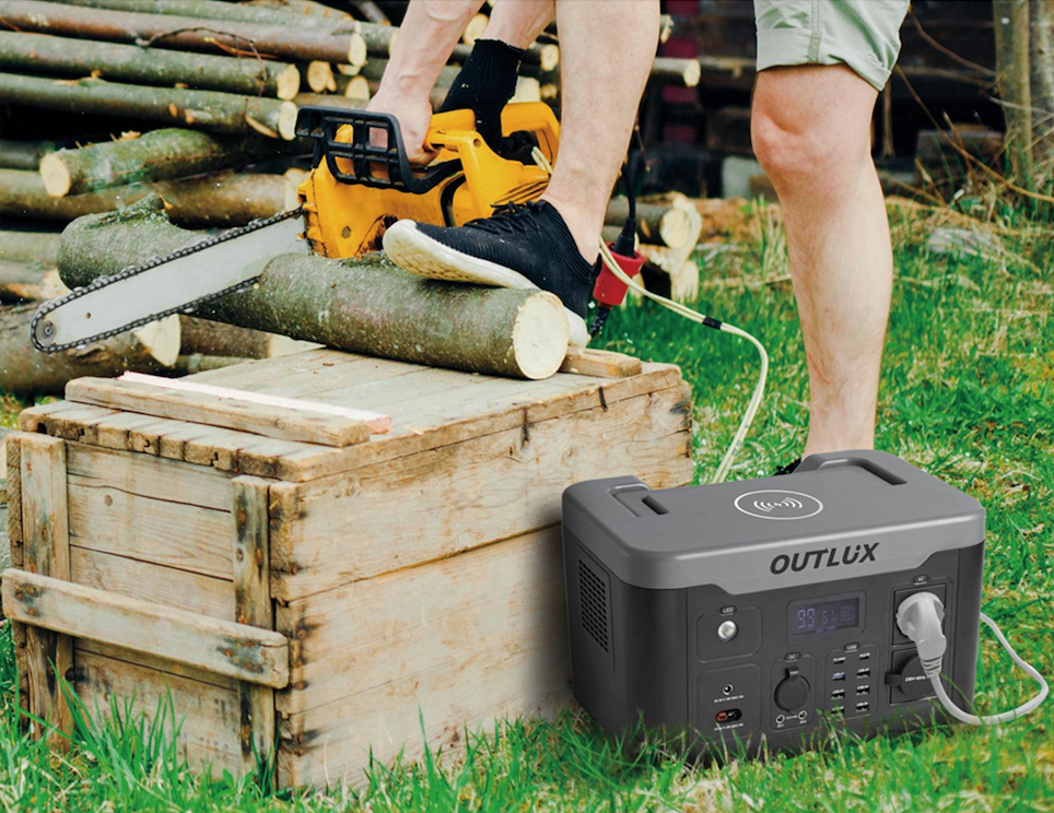 Man using chainsaw powered by portable power pack